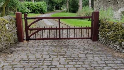 Hardwood Gate with vertical round spindles with a turned detail and curved corner braces