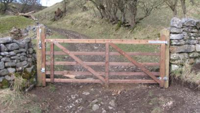 Hartlington 5 bar gate attached to tanalised posts between stone wall