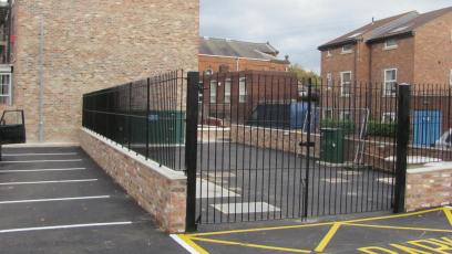 Wrought iron double leaf pair of gates with wall top railings to match