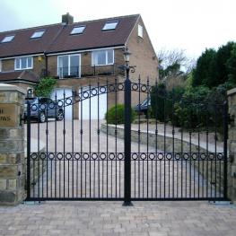 Double leaf pair of wrought iron gates, run off underground motors