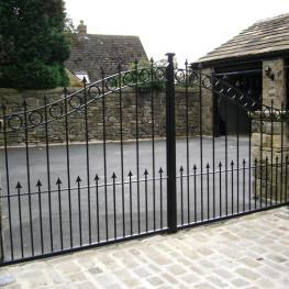 Double leaf pair of wrought iron gates, run off underground motors