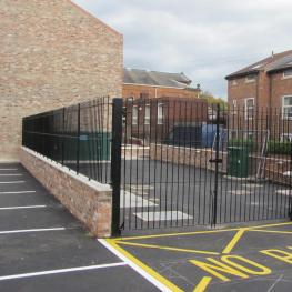 Wrought iron double leaf pair of gates with wall top railings to match